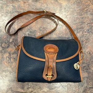Vintage Dooney & Bourke All-Weather Leather crossbody bag in navy blue tan trim